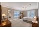 Main bedroom with balcony access, TV stand and ceiling fan at 7840 34Th W Ave # 203, Bradenton, FL 34209