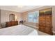 Spacious bedroom with a TV, dresser, and large windows at 7840 34Th W Ave # 203, Bradenton, FL 34209