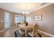 Elegant dining room featuring a table with six chairs, chandelier, and access to a balcony at 7840 34Th W Ave # 203, Bradenton, FL 34209