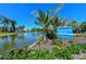 Community entrance with pond and signage for Palma Sola Bay Club at 7840 34Th W Ave # 203, Bradenton, FL 34209