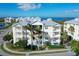 3-story building with light-colored siding, balconies, and palm trees at 7840 34Th W Ave # 203, Bradenton, FL 34209