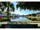 Serene lakefront view with bench and palm trees at 7840 34Th W Ave # 203, Bradenton, FL 34209