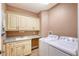Convenient laundry room with cabinets and granite countertop at 7840 34Th W Ave # 203, Bradenton, FL 34209