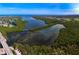 Aerial view of the community featuring lush foliage, bridge access, and beautiful bodies of water at 9514 Colonial Dr, Bradenton, FL 34210