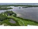 Stunning aerial view of the bay surrounded by lush mangroves and foliage at 9514 Colonial Dr, Bradenton, FL 34210