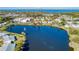 Aerial view of home near lake with fountain feature and lush landscaping at 9514 Colonial Dr, Bradenton, FL 34210