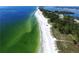Beautiful aerial view of the coastline shows the beach and the water, perfect for nature lovers at 9514 Colonial Dr, Bradenton, FL 34210