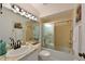 Well-lit bathroom with a shower-tub combination and marble countertops at 9514 Colonial Dr, Bradenton, FL 34210