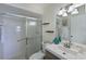 Bright bathroom with a tiled shower, updated vanity, modern lighting, and decorative starfish accents at 9514 Colonial Dr, Bradenton, FL 34210