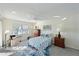 Bright bedroom featuring a ceiling fan, coastal decor, and view of the lake at 9514 Colonial Dr, Bradenton, FL 34210