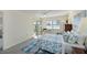 Inviting bedroom with a water view, sliding glass doors, a ceiling fan, and neutral carpeting at 9514 Colonial Dr, Bradenton, FL 34210
