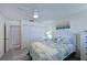 Comfortable bedroom featuring a ceiling fan, patterned bedding and artwork, with an ensuite and closet access at 9514 Colonial Dr, Bradenton, FL 34210