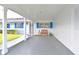 Well-lit carport and front entry with blue shutters creating a welcoming entrance to the home at 9514 Colonial Dr, Bradenton, FL 34210
