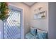 Cozy entryway featuring a decorative mirror and striped bench with decorative pillows, providing a welcoming atmosphere at 9514 Colonial Dr, Bradenton, FL 34210