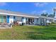 Back of home with patio and outdoor seating overlooking a manicured lawn at 9514 Colonial Dr, Bradenton, FL 34210
