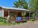 Charming farm market with flowers, produce, and a rustic wooden structure, creating a welcoming and local vibe at 9514 Colonial Dr, Bradenton, FL 34210