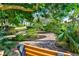 Lush garden pathway with brick pavers, mature trees, and meticulously maintained landscaping at 9514 Colonial Dr, Bradenton, FL 34210
