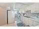 All-white kitchen featuring modern appliances and ample counter space for meal preparation at 9514 Colonial Dr, Bradenton, FL 34210
