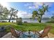 Relaxing lake view featuring outdoor seating area, beautiful blue skies, and lush green landscaping at 9514 Colonial Dr, Bradenton, FL 34210