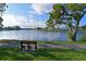 Picturesque view of the lake with a walking path, mature trees, and peaceful setting at 9514 Colonial Dr, Bradenton, FL 34210