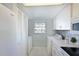 Laundry area conveniently located next to kitchen featuring white appliances at 9514 Colonial Dr, Bradenton, FL 34210