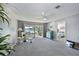 Inviting living room with sliding glass doors offering scenic water views and neutral carpeting, perfect for relaxation at 9514 Colonial Dr, Bradenton, FL 34210