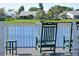 A peaceful patio overlooks the water, with comfortable rocking chairs at 9514 Colonial Dr, Bradenton, FL 34210