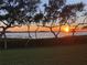 Beautiful sunset view over the water framed by trees, ideal for enjoying serene evenings at 9514 Colonial Dr, Bradenton, FL 34210
