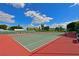 Well-maintained tennis courts on a sunny day with stadium seating available for spectators at 9514 Colonial Dr, Bradenton, FL 34210