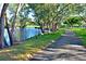 Scenic walking path alongside a pond, lined with trees and ducks at 9514 Colonial Dr, Bradenton, FL 34210