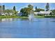 Picturesque lake view with a fountain, lush green lawns, and attractive lakeside homes at 9514 Colonial Dr, Bradenton, FL 34210