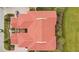 Overhead view of a home's red tile roof, set on a verdant lot, with a car in the driveway at 9623 Sea Turtle Ter # 201, Bradenton, FL 34212