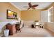 Bright office featuring wood floors, wainscotting, a large screen television, and a sunny window at 9623 Sea Turtle Ter # 201, Bradenton, FL 34212
