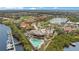 Aerial view of clubhouse showing the pool, surrounding lake, marina and landscaped grounds at 9623 Sea Turtle Ter # 201, Bradenton, FL 34212
