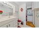 Bathroom with white vanity, toilet and stackable washer/dryer at 1521 Graber Ave, Sarasota, FL 34239