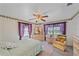 Comfortable bedroom with light-colored bedding and ceiling fan at 1521 Graber Ave, Sarasota, FL 34239
