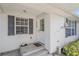 Inviting front entry with steps, white door, and gray shutters at 1521 Graber Ave, Sarasota, FL 34239