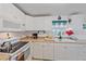 White kitchen with a stove, microwave, and sink at 1521 Graber Ave, Sarasota, FL 34239