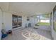 Spacious screened porch with glass-top table and chairs, adjacent to sliding glass doors at 1521 Graber Ave, Sarasota, FL 34239