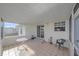 Enclosed porch with tiled floor, table, and chairs, providing ample outdoor space at 1521 Graber Ave, Sarasota, FL 34239