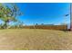 Spacious backyard with a grassy lawn and wooden fence at 1777 Pomelo Dr, Venice, FL 34293