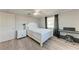 Well-lit bedroom with a full bed, nightstand, and ceiling fan at 1777 Pomelo Dr, Venice, FL 34293