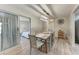 Dining room with table and chairs, view into bedroom and backyard at 1777 Pomelo Dr, Venice, FL 34293