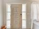 Interior entry door with glass panels and light wood finish at 1777 Pomelo Dr, Venice, FL 34293