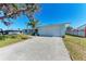 Light blue ranch home with white garage door and a large driveway at 1777 Pomelo Dr, Venice, FL 34293
