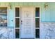 Close up of white front door with circular accents and sidelights at 1777 Pomelo Dr, Venice, FL 34293