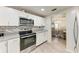 Kitchen with white cabinets, granite counters, and stainless appliances at 1777 Pomelo Dr, Venice, FL 34293