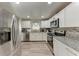 Updated kitchen featuring stainless steel appliances and granite countertops at 1777 Pomelo Dr, Venice, FL 34293