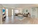 Spacious living area featuring gray sofas and light wood flooring at 1777 Pomelo Dr, Venice, FL 34293