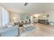 Living room with gray sofas, wood floors, and large windows at 1777 Pomelo Dr, Venice, FL 34293